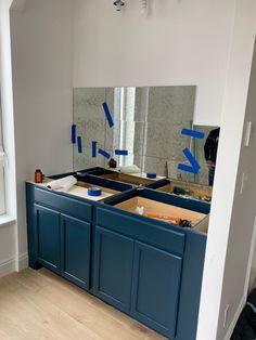 an unfinished kitchen with blue cabinets in the process of remodeling it's walls