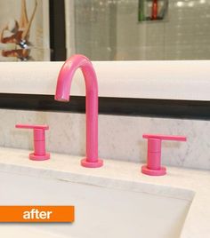 a bathroom sink with three pink faucets on it's sides and a mirror in the background