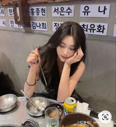 a woman sitting at a table with food in front of her