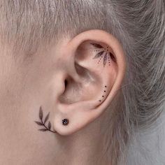 a woman's ear with small leaves on it