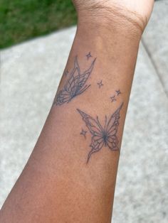 a woman's arm with a butterfly tattoo on the left side of her wrist