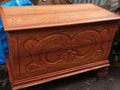 a wooden chest sitting on top of a sidewalk