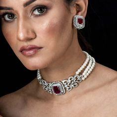 You can channel Princess Diana's iconic style with this Ruby Pearl Necklace. Wear a Ruby Choker Necklace to exude regality, or a Red Diamond Necklace to exude opulence. Choose a Pearl Diamond Choker for a touch of class. Inspired by Princess Diana's timeless style, these pieces combine the allure of rubies with the delicate beauty of pearls and diamonds, adding a touch of royal elegance to any ensemble. *𝐏𝐑𝐎𝐃𝐔𝐂𝐓 𝐃𝐄𝐓𝐀𝐈𝐋* * Material: Brass * Plating: White Rhodium Plated * Stone: AAA- Ruby Pearl Necklace, Luxury Diamond White Pearl Necklace For Wedding, Exquisite Wedding Pearl Necklace With Diamond Accents, Pearl Necklace With Diamond Accents For Wedding, Wedding Jewelry With Pearl And Diamond Accents, Wedding Pearl Necklace With Diamond Accents, Luxury Bridal Necklace With Pearl Drop For Weddings, Elegant White American Diamond Bridal Necklace, Elegant White Bridal Set For Reception