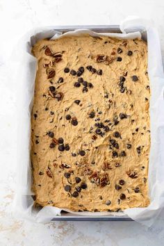 an uncooked loaf of bread with raisins and pecans in it