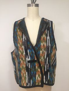 A really amazing and cozy vest made from a wool blend. It is a reversible vest, you can wear it on both sides. Closes by a metallic snap and has a large button on both side. The seams are covered by a black suede piping. The fabric is very colorful and has black, brown, olive, orange, white, turquoise, and gray stripes. The vest is comfortable, light weight and the best you can combined with different pants, skirt, or dresses giving it a unique and stylish look. Dimensions: Bust:   46 inches Len Wool Sleeveless Vest For Winter, Fitted Multicolor Sweater Vest For Fall, Sleeveless Wool Vest For Winter, Winter Sleeveless Wool Vest, Multicolor Sleeveless Sweater Vest For Fall, Fitted Multicolor Sweater Vest For Winter, Fitted Multicolor Vest For Winter, Multicolor Fitted Winter Vest, Multicolor Sleeveless Vest For Fall