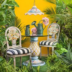 two chairs and a table with vases on it