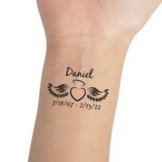 a wrist tattoo with an angel and heart on the left side of its arm, which reads