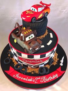 a birthday cake made to look like cars and trucks