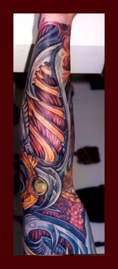 a man's arm with an artistic tattoo design on it, in the middle of his body