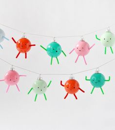 a group of small plastic toys hanging from a line