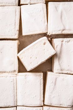 several square pieces of white cake sitting on top of each other