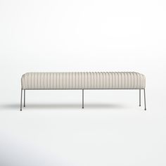 a white bench sitting on top of a white floor