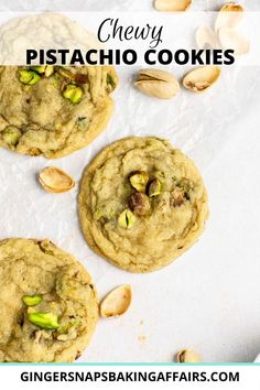 three pistachio cookies on top of parchment paper with almonds in the background