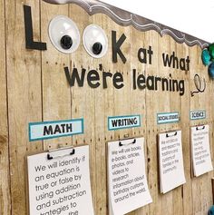 a bulletin board that has been decorated with magnets and eyeballs on the wall