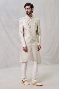 Light beige sherwani with thread embroidery. Paired with cream churidar. - Aza Fashions Designer Cream Kurta For Eid, Designer Cream Bandhgala With Cutdana, Formal Cream Churidar With Chikankari Embroidery, Designer Cream Kurta With Zari Work, Off White Fitted Bandhgala Straight Kurta, Off White Fitted Bandhgala Kurta, Fitted Off White Bandhgala Straight Kurta, Designer Cream Kurta With Naqshi Detailing, Designer Cream Kurta With Dabka