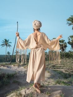 Natural Beige Boho dress I made from very beautiful natural beige cotton. It has fringee on the sleeves. Oversize cut make it comfy to wear and belt helps to make outfit elegant. The dress is open back and has a v-neck cut in front. This dress is super special in my collection. It's all about Love and Freedom. It's perfect for any occasion going out or flowing in it at home. You can wear it super free or with the belt. Being inspired by the grace, power, wisdom, elegance of white eagle, once in Peasant Style Boho Tunic Dress For Beach, Bohemian Boho Dress With Fringe For Beach, Hippie Boho Dress With Fringe For Vacation, Bohemian Boho Dress With Fringe For Beach Cover-up, Bohemian Cotton Boho Dress With Tassels, Bohemian Linen Boho Dress For Beach, Bohemian Style Linen Boho Dress For Beach, Beige Boho Dress For Festival In Hippie Style, Bohemian Boho Dress With Back Tassel For Festival