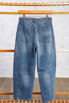 Try out this year's hottest denim trend with our medium wash Barrel Denim! Featuring a button and zip fly, belt loops, and front pockets, these jeans offer both style and functionality. Perfect for adding a modern touch to your wardrobe. Model has on the small. Runs true to size. Mid rise. 68% Cotton, 30% Polyester, 2% Spandex Brand - Miou Muse Measurements - from waist to bottom hem 35.5 inches Acid Wash Denim Mid-rise Bottoms, Washed Blue Mid-rise Rigid Denim Bottoms, Medium Wash Mid-rise Rigid Denim Bottoms, Pre-washed Denim Blue Wide Leg Bottoms, Mid-rise Rigid Denim Bottoms With Button Closure, Denim Trends, Medium Blue, New Arrival Dress, Shoe Sale