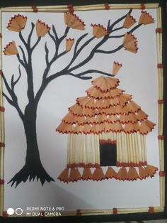 an art project made out of paper with a tree and a house on it's side