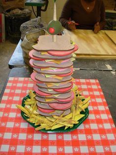 a stack of hamburgers sitting on top of a green plate