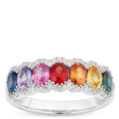 A beautiful rainbow of sapphires for a celebration of love and beauty. Seven stunning oval cut sapphires each showcase their deep natural color and beauty. Each stone is complimented with sparkling round cut diamonds and 14K white gold making this incredible ring a perfect choice to brighten every day or dazzle during the most special events. Fine Jewelry Multicolor Oval Gemstones, Multicolor Oval Gemstones For Anniversary, Oval Multicolor Gemstones For Anniversary, Multicolor Sapphire Ring With Brilliant Cut, Multicolor Sapphire Ring In Fine Jewelry Style, Multicolor Brilliant Cut Sapphire Ring, Multicolor Sapphire Multi-stone Ring, Multicolor Multi-stone Sapphire Ring, Multicolor Oval Sapphire Ring With Diamonds