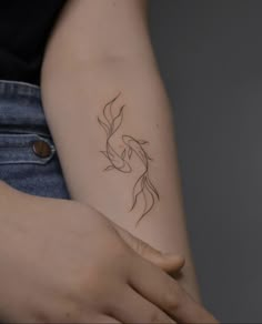 a woman's arm with a small tattoo on the left side of her arm