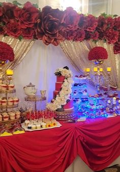 a red table topped with lots of desserts and cupcakes