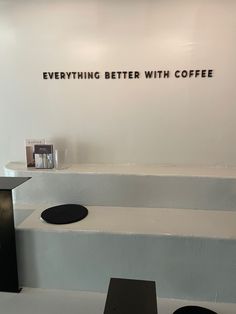 there is a sign that says everything better with coffee on the wall next to it