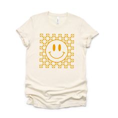 Looking for a cute versatile top to wear this summer? Make sure to grab one of our Mustard Smiley Face tees! This soft and comfortable graphic tee is the perfect top for any outfit. It can be paired with biker shorts, jeans, or even a simple skirt/dress! This tee is true-to-size, so be sure to order your regular t-shirt size! If you are looking for a more oversized look, make sure to size up! Retro Summer Tops For Everyday Wear, Retro Summer Tops For Everyday, Spring Crew Neck Top With Smiley Face, Spring Smiley Face Crew Neck Top, Cute Smiley Face Tops For Summer, Trendy Smiley Face Summer Tops, Cute Smiley Face Summer Tops, Summer Cotton Tops With Smiley Face, Cotton Smiley Face Top For Summer