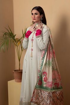 A long chiffon kalidar suit featuring similarly flared pants in shimmering golden silk. The suit features full mukesh work. Paired with a printed dupatta with with silver sequins.3-Piece SuitReady to wear Silk Anarkali Churidar With Mirror Work, Maxi Length Chanderi Salwar Kameez With Mirror Work, Maxi Length Salwar Kameez With Mirror Work In Chanderi, Anarkali Salwar Kameez In Tissue Silk With Naqshi, Party Sharara In Organza With Naqshi Detailing, Organza Sharara With Naqshi For Party, Party Sharara With Naqshi In Organza, Festive Anarkali Set With Naqshi In Tissue Silk, Festive Tissue Silk Anarkali Set With Naqshi