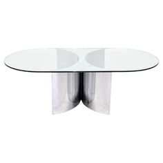 a glass table with two metal legs and a curved top, on a white background