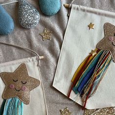 two little bags that have some kind of decoration on them, one has a star and the other has a unicorn