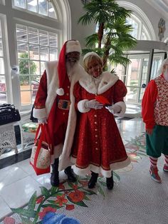 two people dressed as santa claus and mrs claus