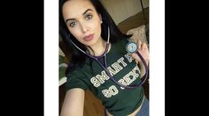 a woman with a stethoscope on her neck is taking a selfie