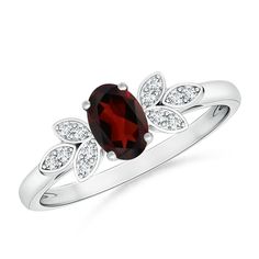 A scintillating oval garnet in a four prong setting is featured at the center of this vintage inspired ring. Brilliant diamond studded leaf motifs adorn the shoulders, highlighting the reddish brown gemstone. Designed in platinum, this stunning oval garnet ring elegantly elevates your look. Garnet Ring Vintage, Ruby Ring Vintage, Garnet Ring Silver, Red Garnet Ring, Vintage Inspired Rings, Brown Gemstone, Vintage Diamond Rings, Ring With Diamond, Garnet Jewelry