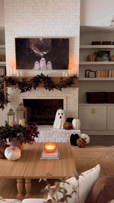 a living room filled with furniture and a fire place covered in candles next to a fireplace