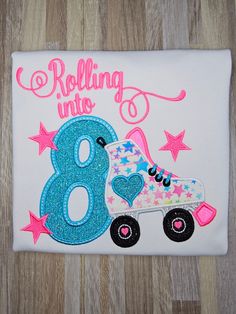 a birthday shirt with the number eight and rollerblading in pink, blue and white