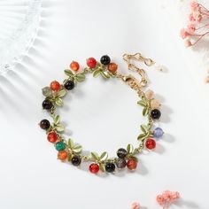 Wrap your wrist in the vibrant hues of nature with our Multi Berry Bracelet. This delightful accessory features an assortment of berry-inspired beads, creating a playful and colorful ensemble. Whether you're looking to add a touch of freshness to your everyday wear or complement a festive outfit, this bracelet is a versatile and charming choice. Embrace the sweetness of nature with the Multi Berry Bracelet, a lively addition to your jewelry collection. DETAILS Plating: 18K Gold Materials:   18K Multicolor Hand-strung Pearl Bracelet, Gift Multicolor Polished Beads Crystal Bracelet, Multicolor Polished Beads Crystal Bracelet For Gift, Colorful Flower Bracelets As Gift, Colorful Flower Bracelets For Gifts, Colorful Flower-shaped Bracelets For Gifts, Multicolor Charm Bracelet With Natural Round Beads, Multicolor Pearl Bracelet With Natural Stones As Gift, Multicolor Charm Bracelet With Natural Stones And Round Beads