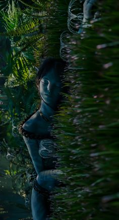 a woman is hiding behind some plants