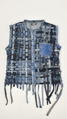 a piece of clothing that is made out of denims and other material, with fringes on the sides