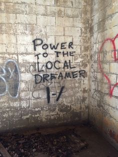 graffiti is spray painted on the wall in an abandoned room