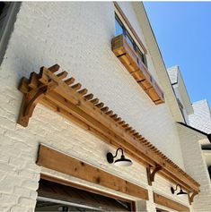 an outside view of a house with wood trimming