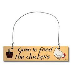 a wooden sign that says gone to feed the chickens with a chicken and basket hanging from it