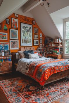 a bedroom with an orange wall and lots of pictures on the walls above the bed