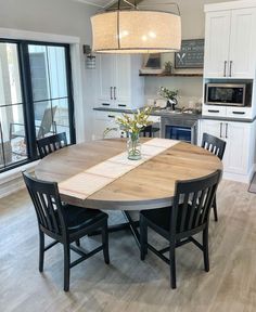 a kitchen table with four chairs around it