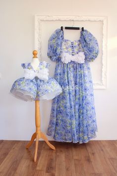 We are delighted to offer you an exquisite set of handmade dresses for mother and daughter, crafted exclusively to order. These unique dresses are made from organza with a beautiful floral print, perfect for creating unforgettable matching outfits. The back of each dress is adorned with a bow made of voluminous flowers, adding a touch of elegance and charm. The child's dress features short sleeves decorated with the same voluminous flowers, a knee-length full skirt, and a playful, princess-like silhouette. The mother's dress boasts a floor-length skirt, voluminous sleeves, and a draped bodice, combining style and sophistication. Order these enchanting dresses now using our standard size chart. If you prefer a custom fit, please contact us, and we will be delighted to create dresses tailore Mother And Daughter Dresses, Wedding Guest Dress Formal, Summer Wedding Guest Dress, Photo Shoot Dress, Mother Daughter Dress, Summer Wedding Guest, Mommy And Me Dresses, Mommy And Baby, Photoshoot Dress