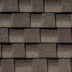 the roof of a house with dark shingles