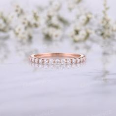 a rose gold wedding band with five diamonds