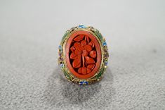 I am offering you this fabulous vintage sterling silver, with yellow gold overlay  (stamped)  band ring. This piece is distinctive and stunning with the following features: It features a large oval shaped fancy carved bezel set genuine cinnabar stone.  This stone is accented with endless amounts of scrolled filigree design work and multi colored enameling. This stone is set in a distinctive single stone raised relief  design setting. What a fantastic Art Deco style ring we have here. It is curre Relief Design, Red Stone Ring, Gold Overlay, Filigree Design, Single Stone, Stone Setting, Fantastic Art, Vintage Band, Red Stone