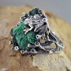 The ring of Melant is made manually of 925 sterling silver and natural plaid malachite. The ring is manually assembled directly on the stone. Each ring is individual and unique. The texture of plisse malachite resembles the interweaving of overgrown branches of a shrub, and the luster of the polished surface is akin to the dull flicker of twisted silk. Such a stone can be used in contrast with turquoise malachite - mainly as a low-expressive background. Malachite is a stone that perfectly combin Nature-inspired Green Jewelry With Raw Stone, Unique Green Jewelry With Raw Stone, Unique Sterling Silver Green Emerald Ring, Unique Sterling Silver Emerald Ring For May Birthstone, Green Sterling Silver Nature-inspired Ring, Green Sterling Silver Jewelry With Raw Stone, Handmade Green Emerald Ring, Nature-inspired, Handmade Nature-inspired Green Emerald Ring, Green Nature-inspired Sterling Silver Rings