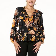 Colleen Lopez Printed Knit Ruffle Blouse  Whether at work or at play, get ready to style out wearing this printed jersey knit blouse with ruffle detail. The elastic waist provides much-needed comfort, while the tiered peplum bottom adds a touch of elegance to your look. Fall V-neck Top With Ruffle Hem, Casual Fall Peplum Top For Brunch, Floral Print Stretch Tops For Work, Stretch Floral Print Tops For Work, Fall Peplum Top For Brunch, Black Floral Print Tops For Fall, Black Ruffle Hem Tops For Fall, Casual Peplum Top With Ruffle Hem For Fall, Casual Fall Peplum Top With Ruffle Hem